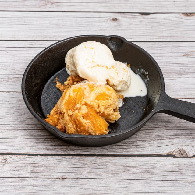 Peach Cobbler With Butter Rum Sauce & Ice Cream.