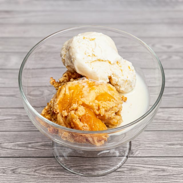 Peach Cobbler With Butter Rum Sauce & Ice Cream.